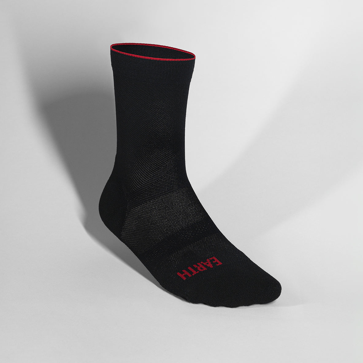 Black ultralight race day sock with breathable fibers and targeted compression.